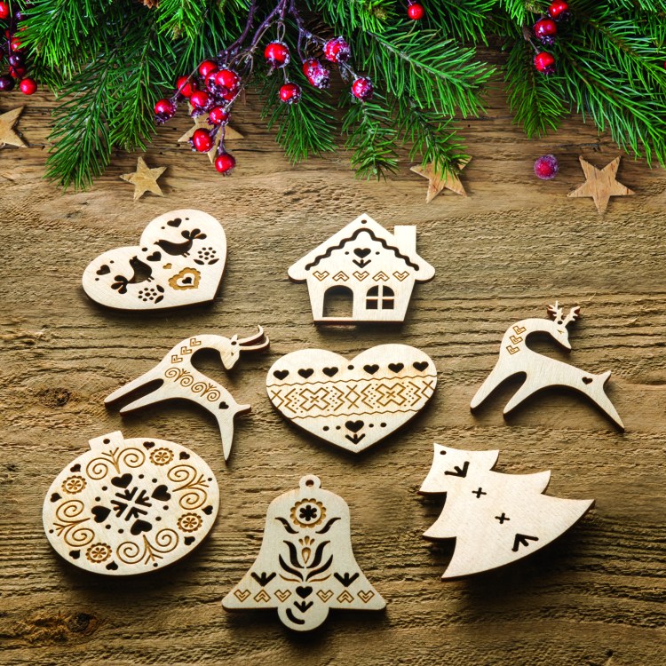 A set of laser cut and engraved wooden Christmas ornaments with Cicmany pattern.