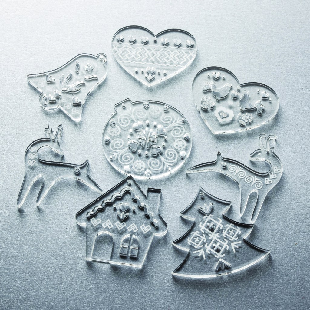 A set of laser cut and engraved transparent acrylic Christmas ornaments with Cicmany pattern.